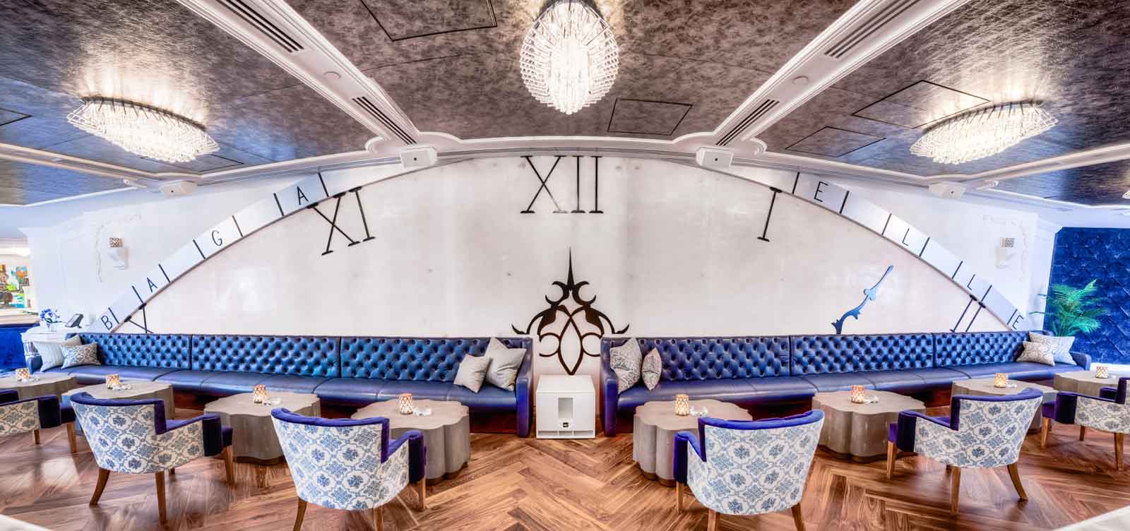 The bar area at Bagatelle Fairmont Dubai features an oversized clock motif