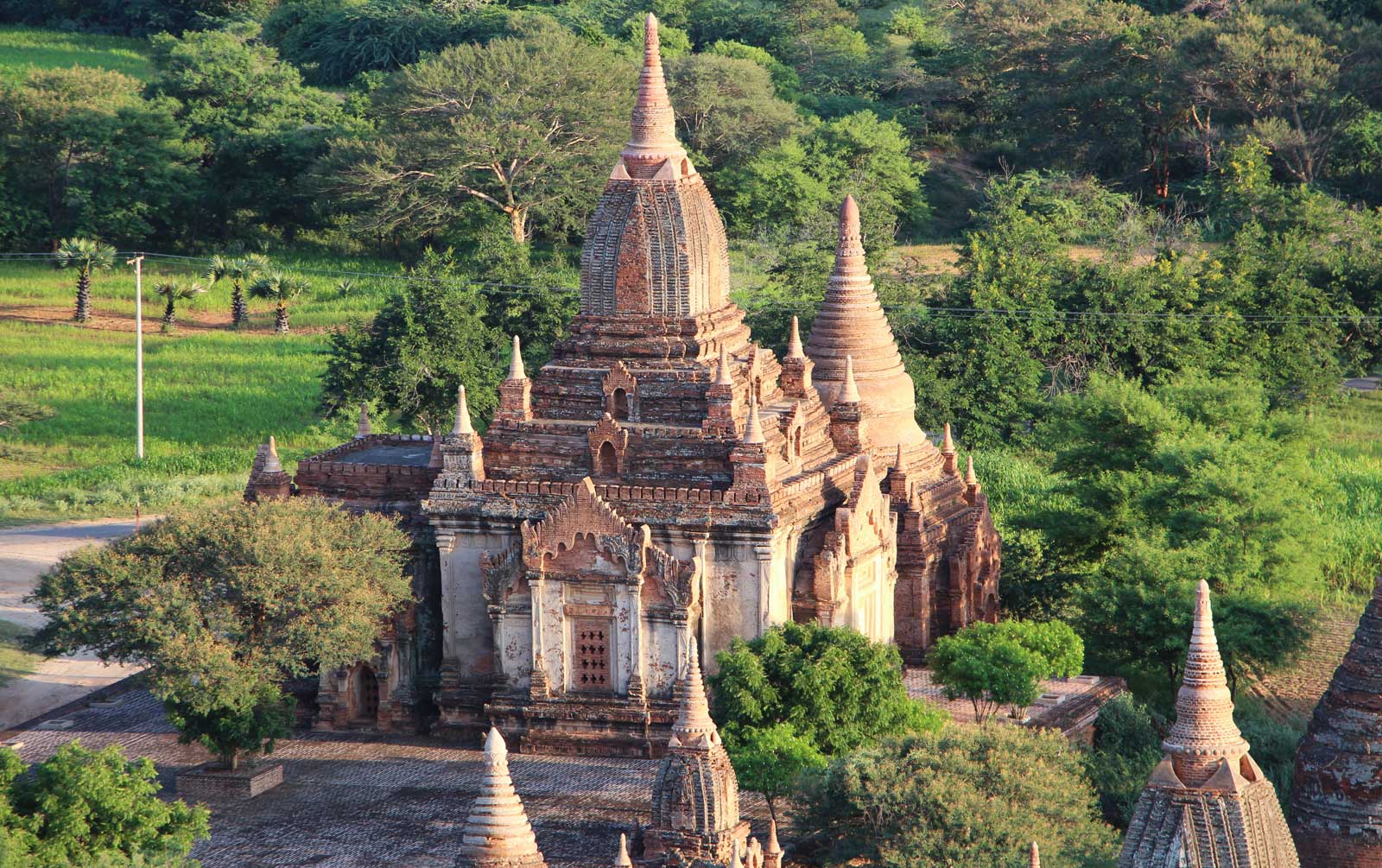 Myanmar temple surrounded by green