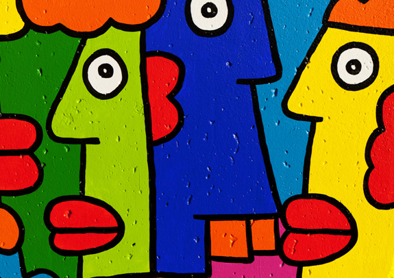Pictured above: cartoon faces painted on the Berlin Wall by street artist Thierry Noir