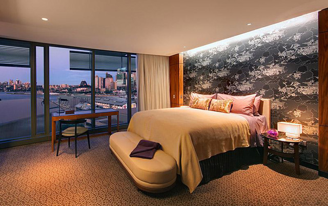 The suite's bedroom boasts city and harbour views